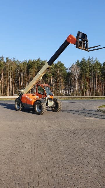 Telescopic forklift at a construction site.