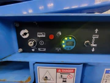 Industrial machine control panel with LED indicators.