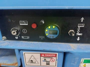 Machine control panel with LCD display and buttons.