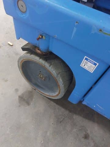 An inflated forklift tire with damage.