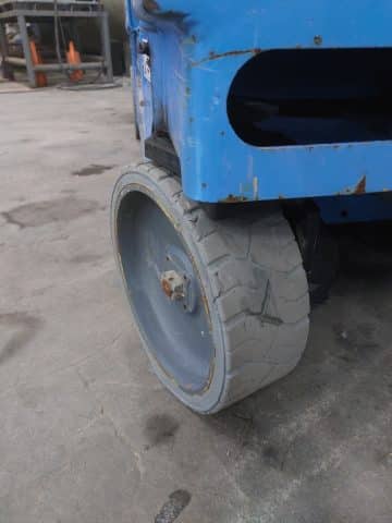A worn forklift wheel in the workshop.