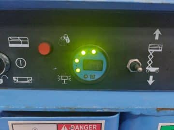 Machine control panel with LED display and buttons.