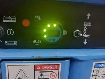 Machine control panel with green indicators and LCD display.