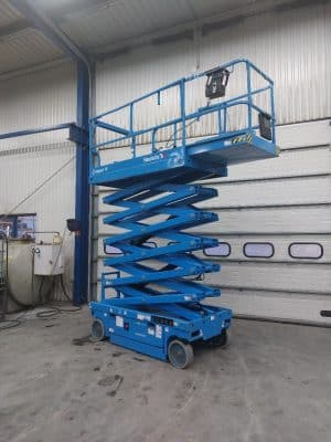 Blue Haulotte scissor lift in the hall.