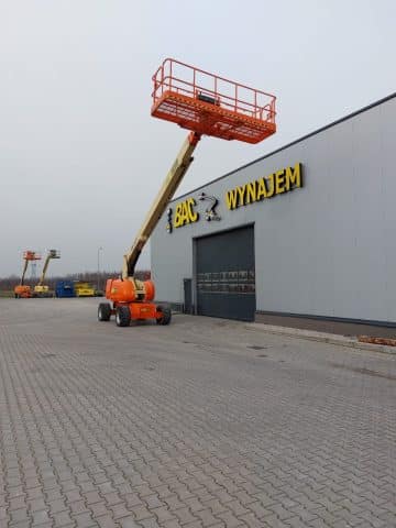 Scissor lift at the warehouse, "Rental" sign.