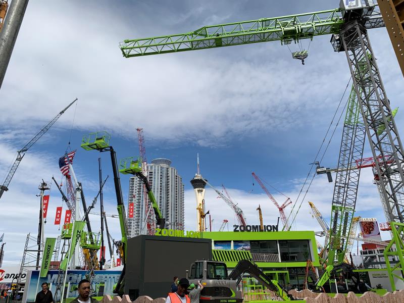 Construction fair, cranes, skyscrapers in the background.