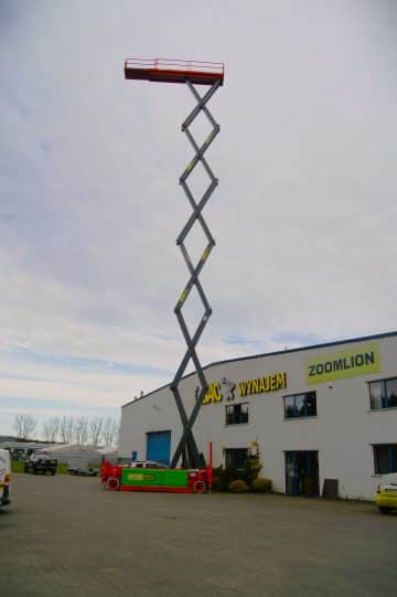 A basket lift on a boom in front of the building.
