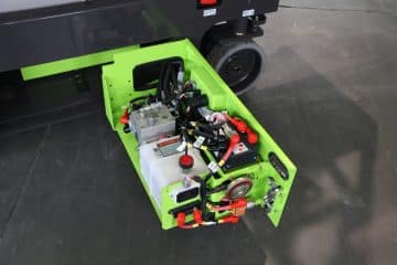Zelený vysokozdvižný vozík, pohľad na batériu a motor.