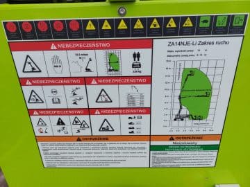 Tablica ostrzeżeń i specyfikacji maszyny budowlanej.